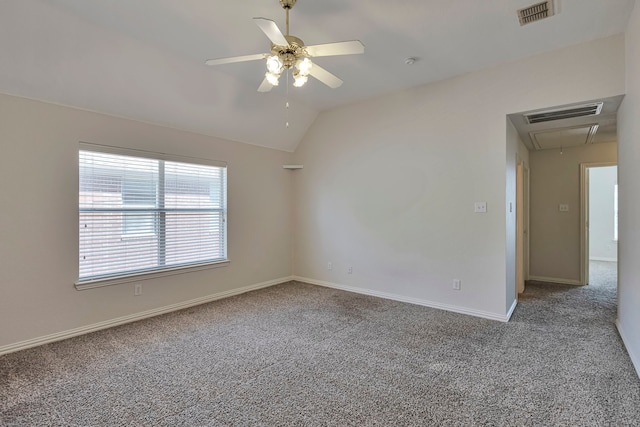 carpeted spare room with vaulted ceiling and ceiling fan