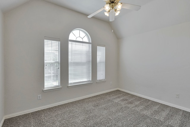 carpeted empty room with vaulted ceiling and ceiling fan