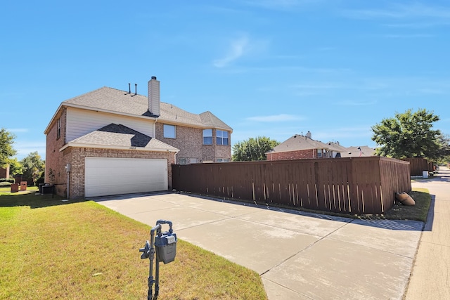 view of front of home with a garage and a front yard