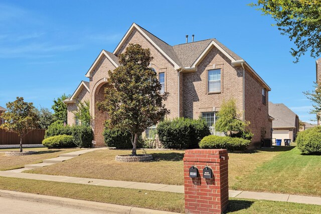 view of front property with a garage and a front lawn