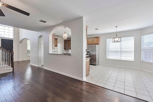 unfurnished living room with light wood-type flooring, sink, and ceiling fan