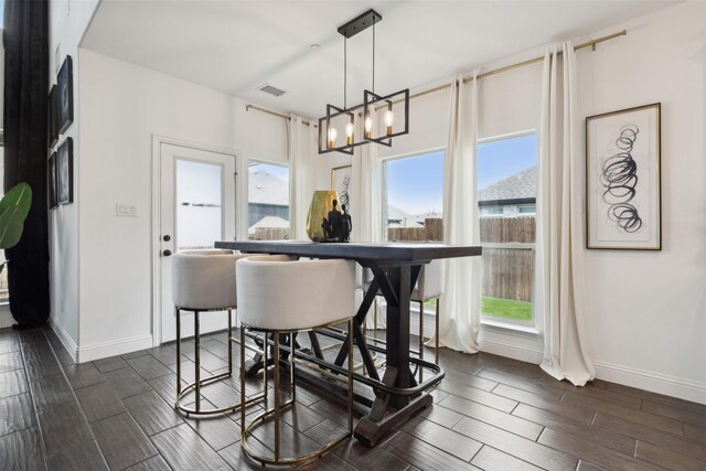 dining room with a chandelier and dark hardwood / wood-style flooring