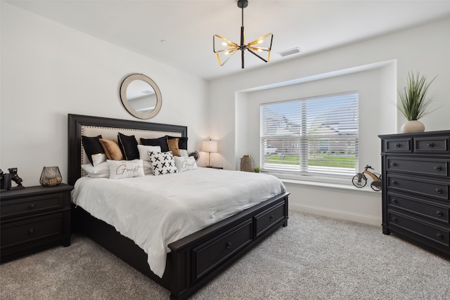 carpeted bedroom featuring an inviting chandelier