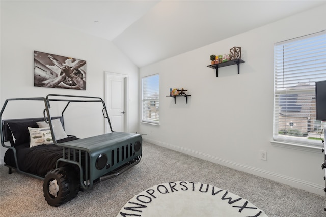 carpeted bedroom with vaulted ceiling and multiple windows