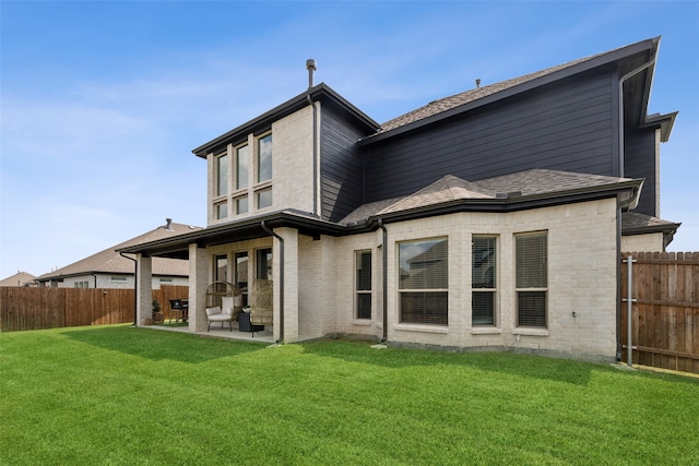 back of house with a lawn and a patio area