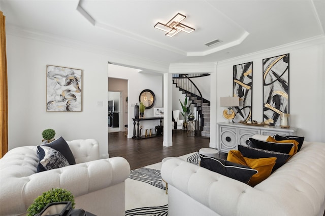 living room featuring dark hardwood / wood-style floors and crown molding