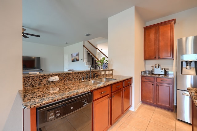 kitchen with a kitchen island, dishwasher, dark stone countertops, sink, and ceiling fan