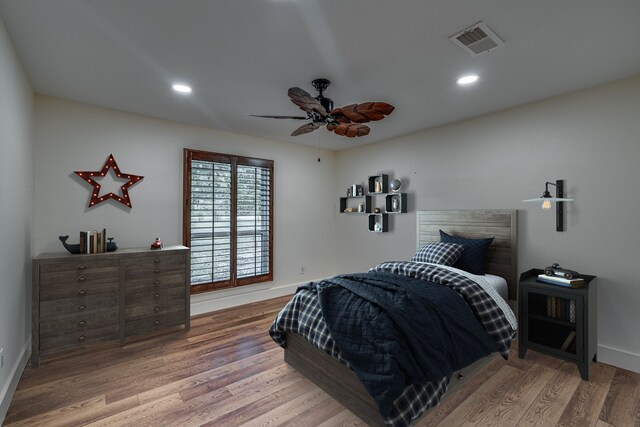 bedroom with hardwood / wood-style flooring and ceiling fan