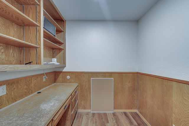 interior space featuring wood walls and light hardwood / wood-style flooring