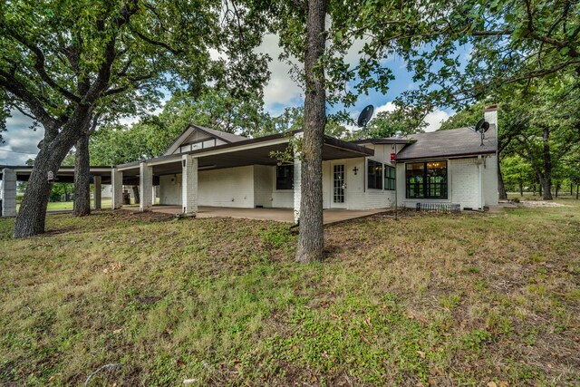 exterior space featuring a front yard and a patio area