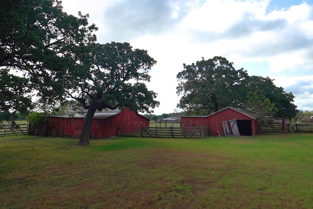 view of yard with an outbuilding and a rural view