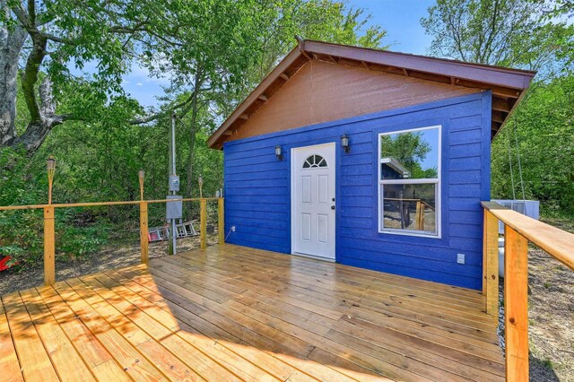 wooden terrace featuring an outbuilding