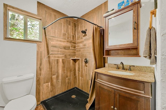 bathroom featuring curtained shower, toilet, a textured ceiling, and vanity