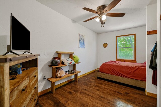 bedroom with ceiling fan and dark hardwood / wood-style flooring