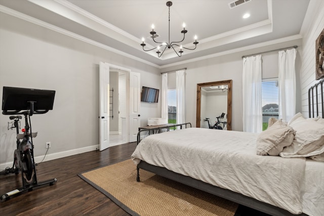 bedroom with ornamental molding, an inviting chandelier, a raised ceiling, and dark wood-type flooring