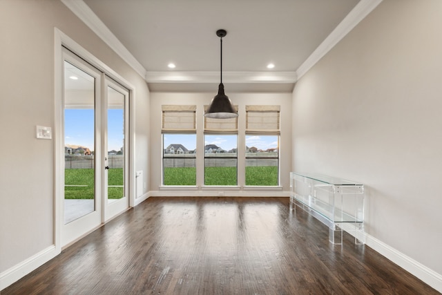 spare room featuring dark hardwood / wood-style floors and ornamental molding