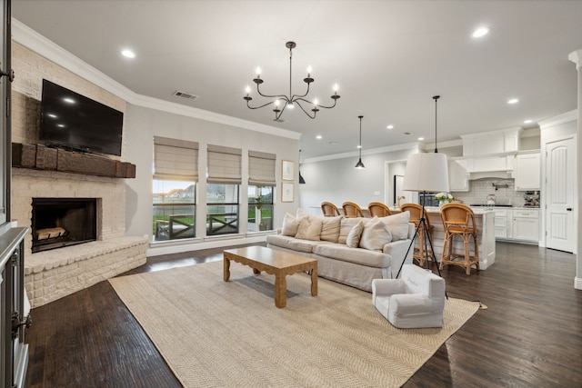 living room featuring wood-type flooring, ornamental molding, and a brick fireplace