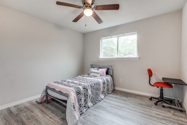 bedroom with light hardwood / wood-style flooring and ceiling fan