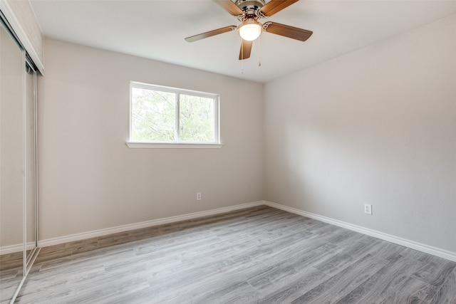 spare room featuring light hardwood / wood-style flooring and ceiling fan