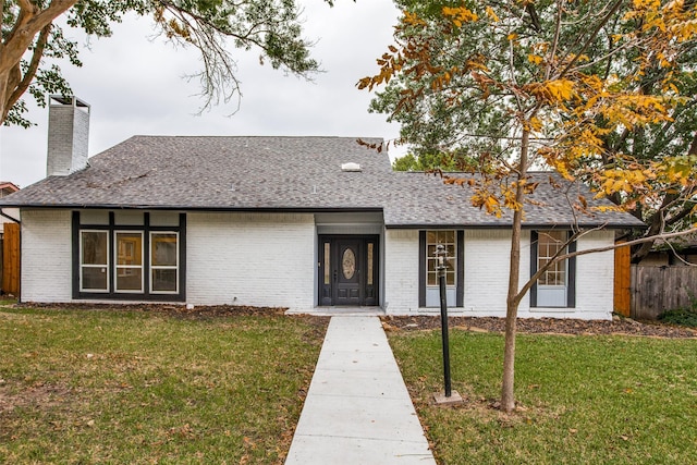 ranch-style home with a front lawn