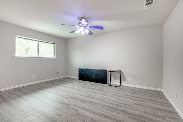 empty room with ceiling fan and light wood-type flooring