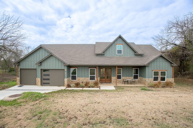 craftsman inspired home with a patio area and a garage