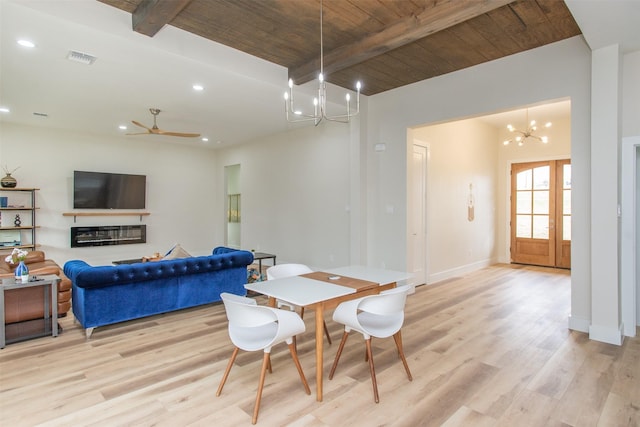 dining space with beam ceiling, ceiling fan with notable chandelier, light hardwood / wood-style flooring, and wooden ceiling