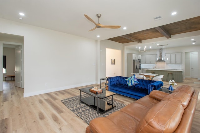 living room with beamed ceiling, light hardwood / wood-style floors, ceiling fan, and wooden ceiling