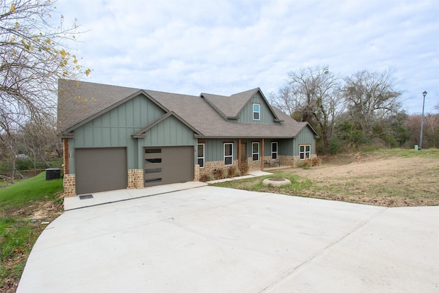 craftsman inspired home with a garage and central AC unit