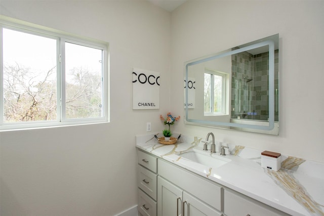 bathroom with plenty of natural light and vanity