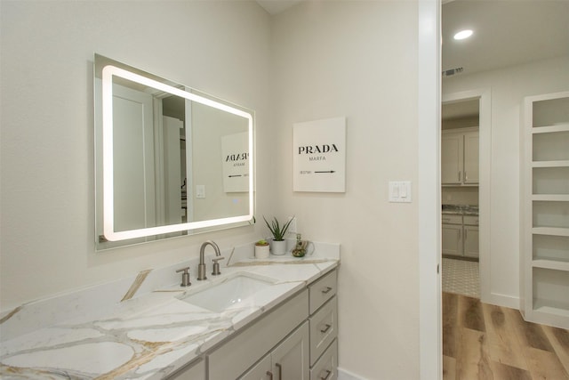 bathroom featuring vanity and hardwood / wood-style flooring