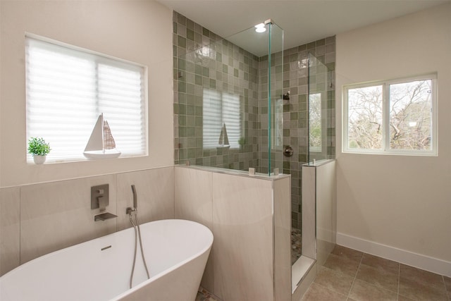 bathroom with shower with separate bathtub, tile patterned floors, and a healthy amount of sunlight