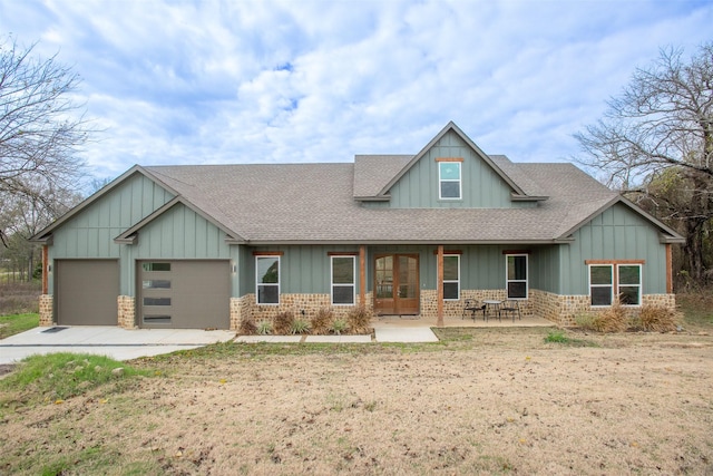 craftsman-style home featuring a garage and french doors