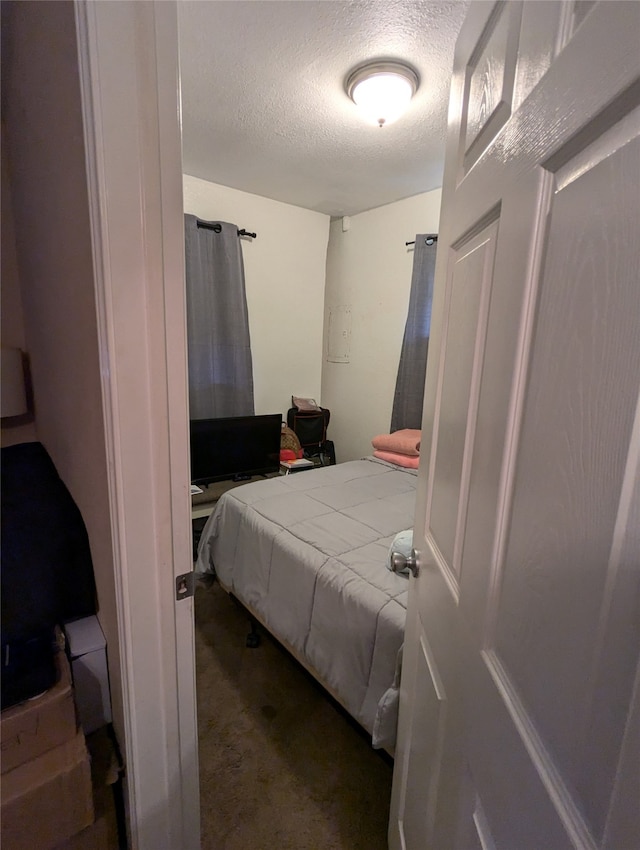 carpeted bedroom featuring a textured ceiling