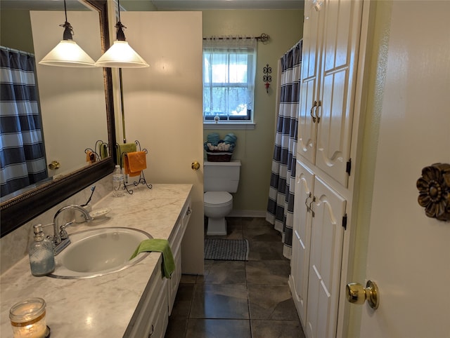 bathroom featuring tile patterned floors, toilet, and vanity