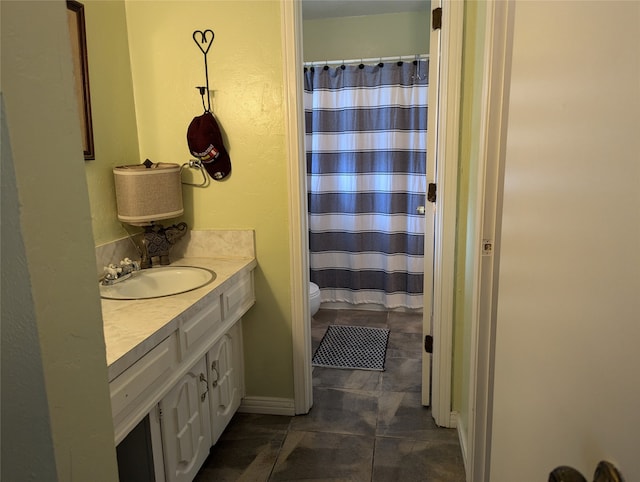 bathroom featuring vanity, toilet, and tile patterned flooring