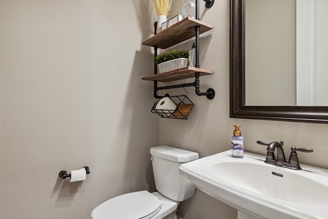 bathroom with toilet and sink