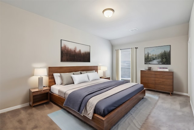 carpeted bedroom with lofted ceiling