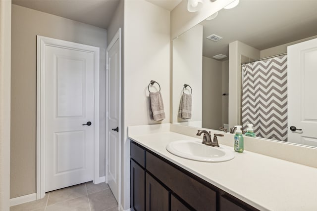 bathroom featuring tile patterned flooring, vanity, and a shower with curtain