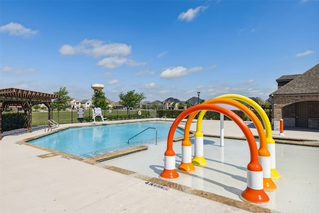 view of swimming pool with a patio and a pergola