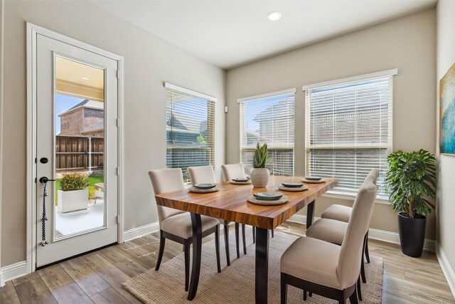 dining area featuring a healthy amount of sunlight and light hardwood / wood-style floors