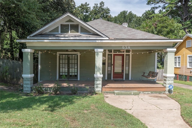 view of front of property with covered porch and a front yard