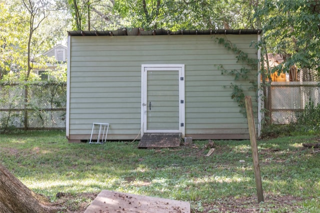 view of outbuilding with a lawn