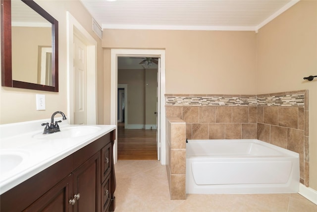 bathroom with a washtub, vanity, crown molding, and tile patterned flooring