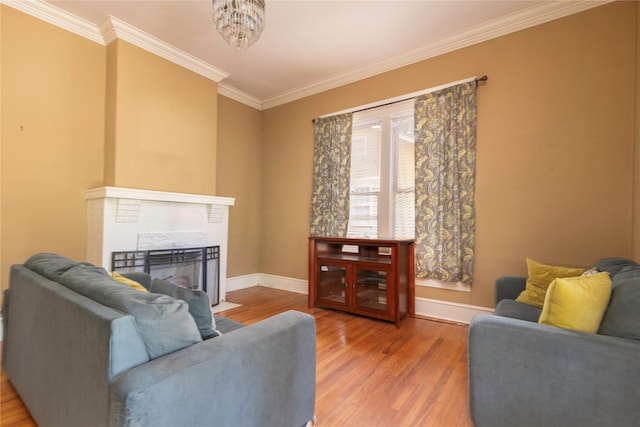 living room featuring hardwood / wood-style floors, ornamental molding, and a chandelier