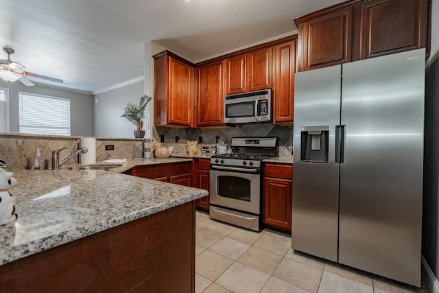 kitchen with backsplash, sink, light tile patterned floors, appliances with stainless steel finishes, and light stone counters