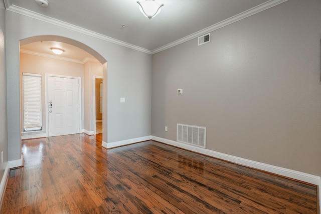 unfurnished room featuring crown molding and dark hardwood / wood-style flooring