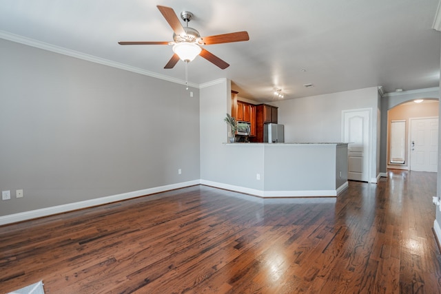 unfurnished living room with ceiling fan, crown molding, and dark hardwood / wood-style flooring