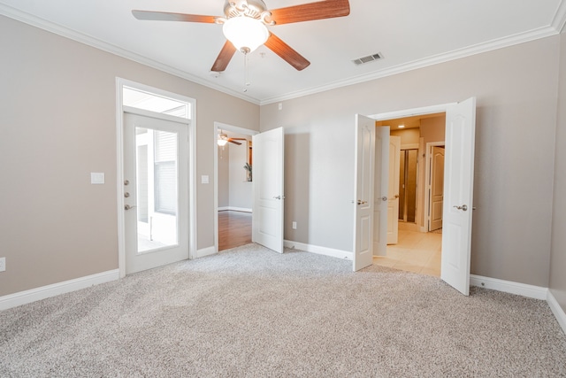 unfurnished bedroom with crown molding, ceiling fan, and light colored carpet