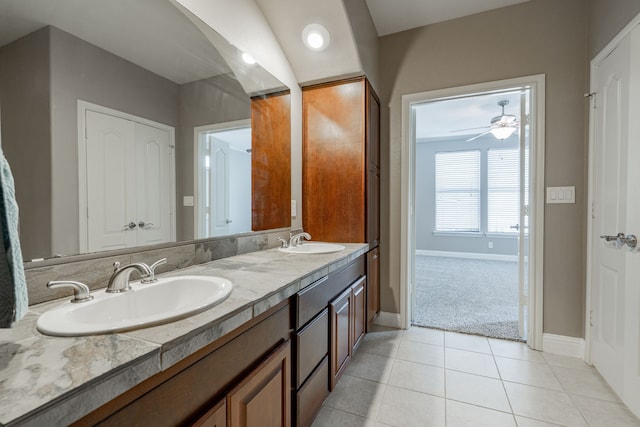 bathroom featuring tile patterned flooring, vanity, and vaulted ceiling